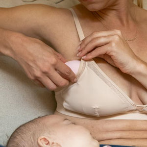 Woman using lactation massager one of the remedies for clogged ducts