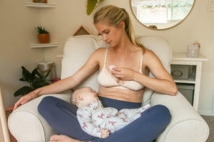 Woman using the Lumama Lactation Massager for engorged breast